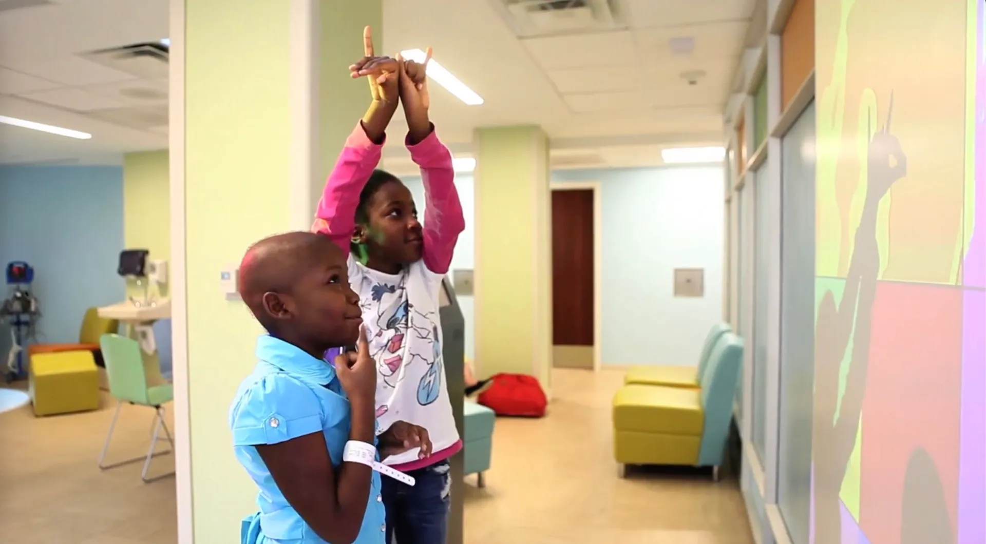 Patients interacting with a colorful sensory wall display